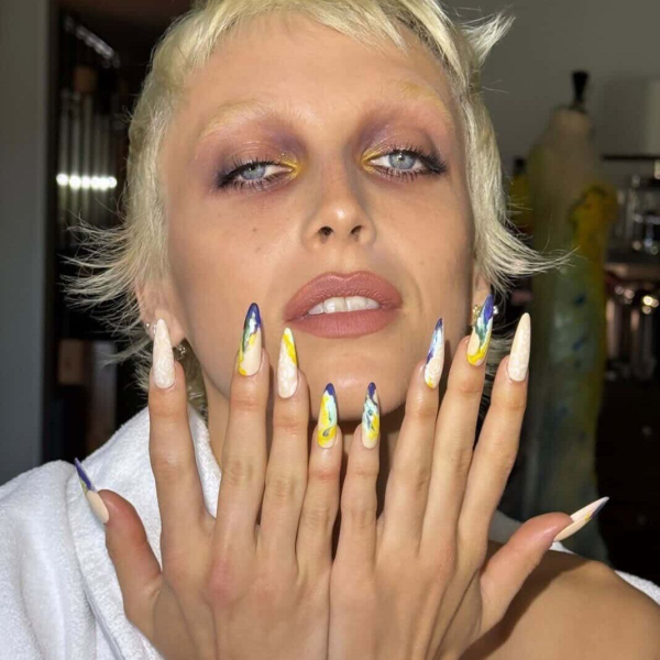 A photo of Emma Chamberlain showing off her paintstroke manicure for the 2026 Met Gala.